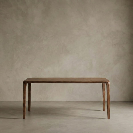 Heirloom-quality North American Black Walnut dining table with curved legs in minimalist room