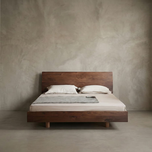 Minimalist bedroom featuring a solid North American black walnut bed with natural finish and neutral bedding