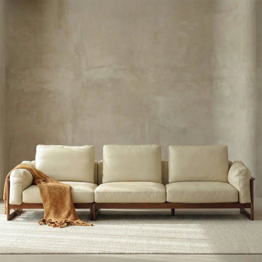 Studio front view of the 3-seater Sylvan Reserve sofa showing the sleek wood base and plush leather cushions.