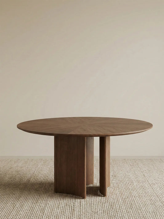 Full studio shot of the Walnutry Kurumi solid wood round table against a neutral background showing the reverse bevel edge.