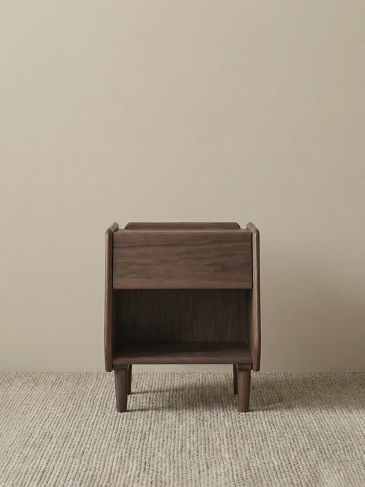 Detail view of solid walnut tapered legs with floor protectors, highlighting structural stability.