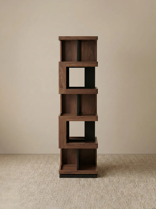 Studio shot of the empty Walnutry Suiseki rotating bookshelf showing the sculptural form and solid wood construction.