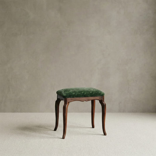Vintage-inspired solid walnut vanity stool with elegant curved legs and a luxurious emerald green velvet upholstered seat.