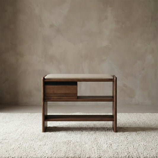 Functional entryway storage bench made of solid black walnut with a cushioned seat, a storage drawer, and a slat shelf for shoes.