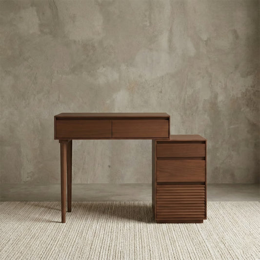 Modern solid black walnut desk featuring a minimalist writing surface and a side cabinet with textured ribbed drawers for stylish home office storage.