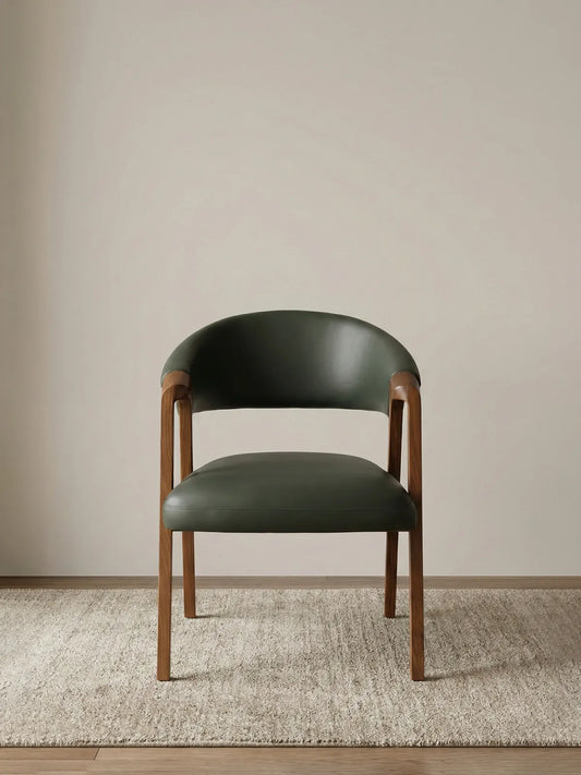 Walnutry modern dining chair featuring a solid North American black walnut frame with a curved backrest and premium olive green leather upholstery.