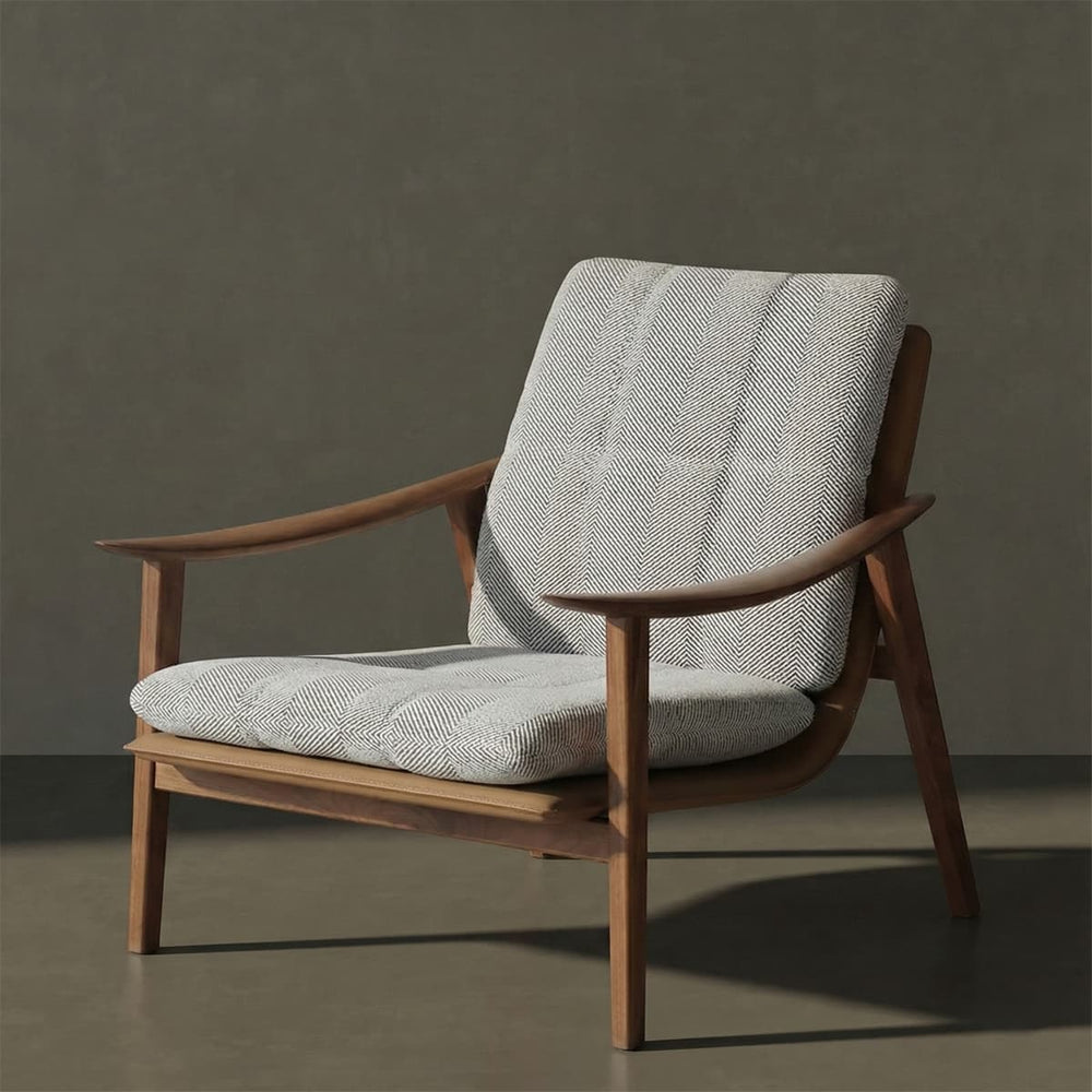 Mid-century modern lounge chair with solid walnut frame and textured light gray cushioned seat and backrest