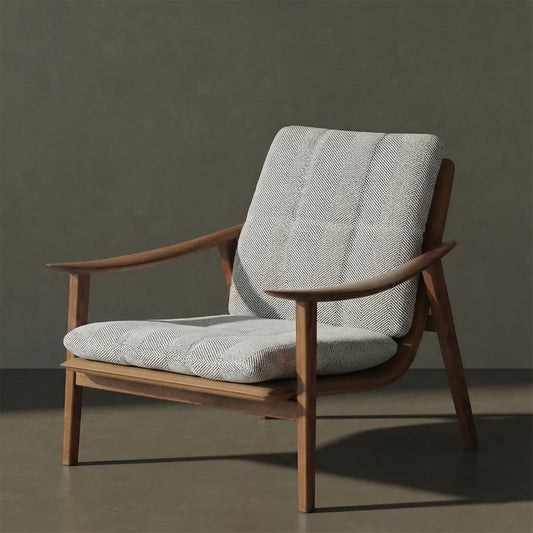 Mid-century modern lounge chair with solid walnut frame and textured light gray cushioned seat and backrest