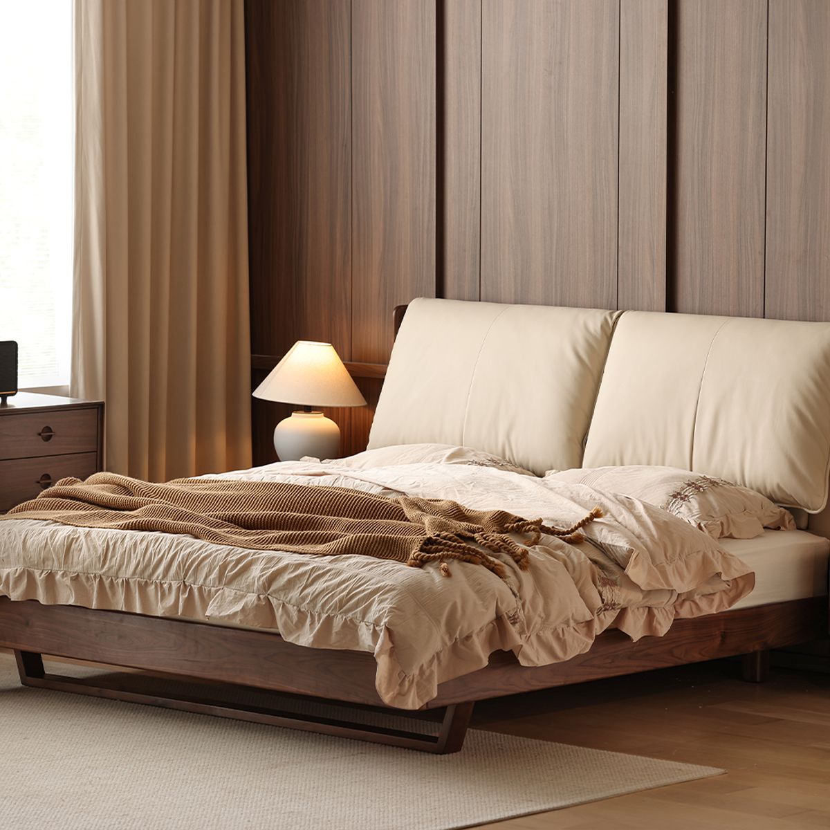 Luxury master bedroom featuring solid black walnut bed frame with beige leather headboard and cozy bedding