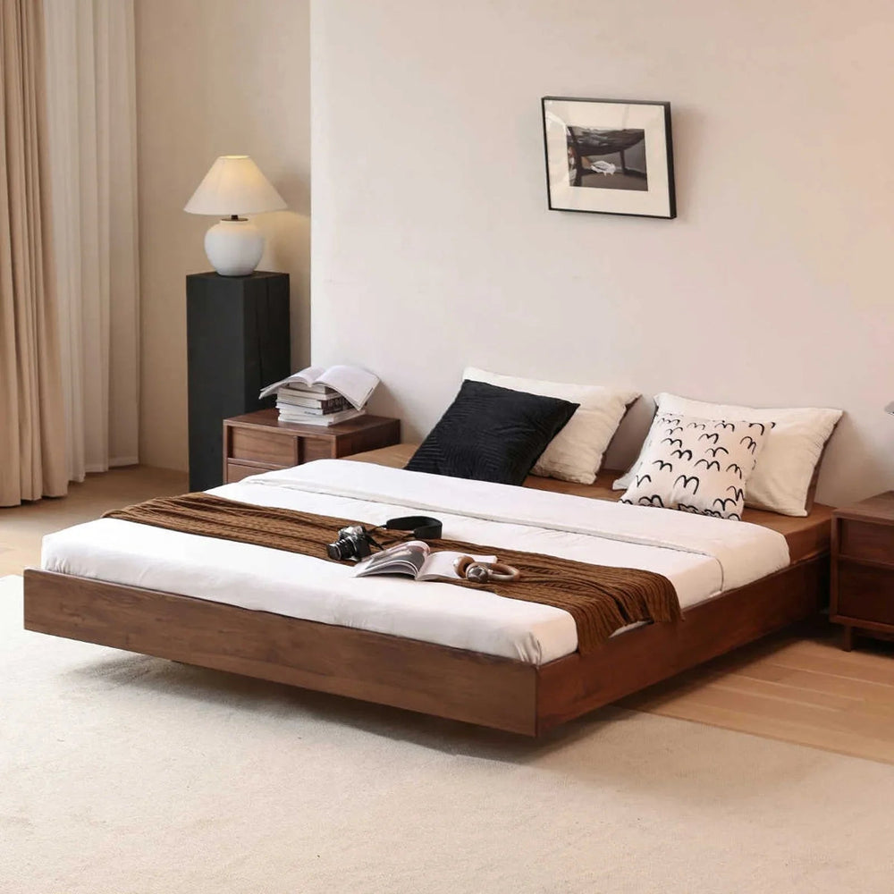 Mid-century modern floating walnut bed in minimalist bedroom with bedside tables, lamp, and wall art