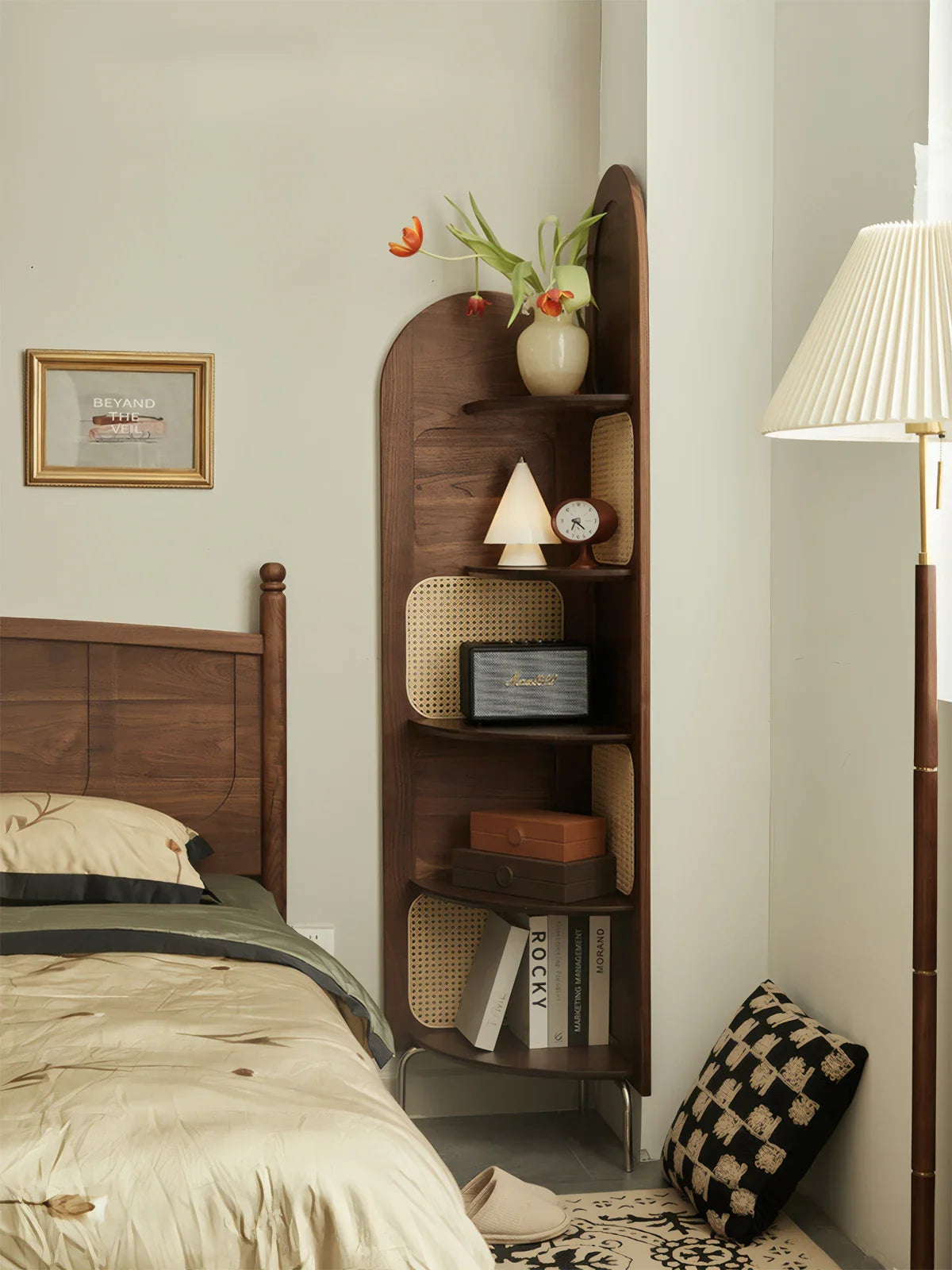 Modern bedroom with walnut bed frame, beige leather headboard, soft beige bedding, knitted throw, and bedside lamp