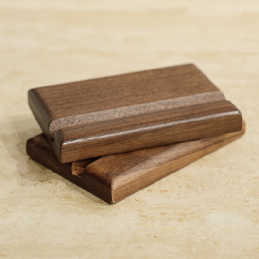Two solid North American Black Walnut wood samples with smooth natural oil finish on beige surface