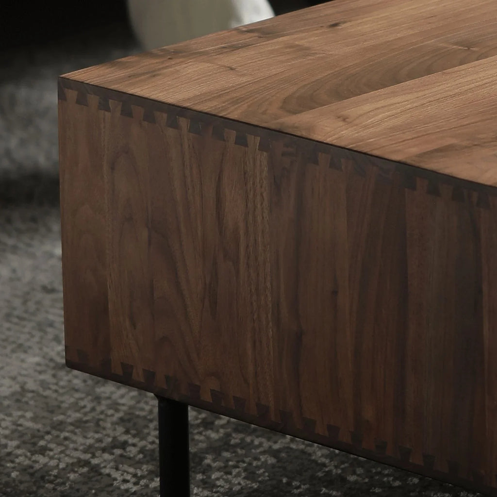 Close-up of 100% solid walnut wood furniture corner with dovetail joints and black metal leg