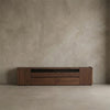 Solid North American Black Walnut low media console with drawers and cabinets against neutral textured wall