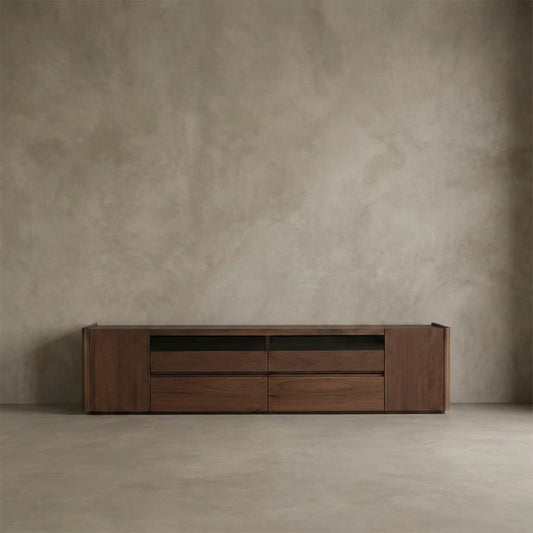 Solid North American Black Walnut low media console with drawers and cabinets against neutral textured wall