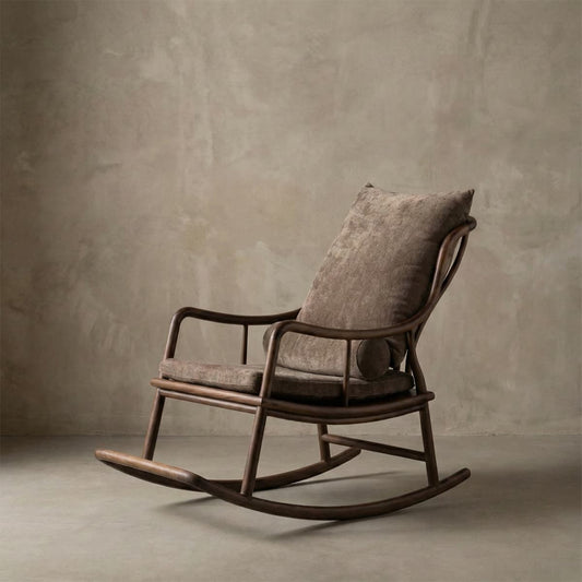 Elegant walnut rocking chair with plush brown cushions against textured beige wall