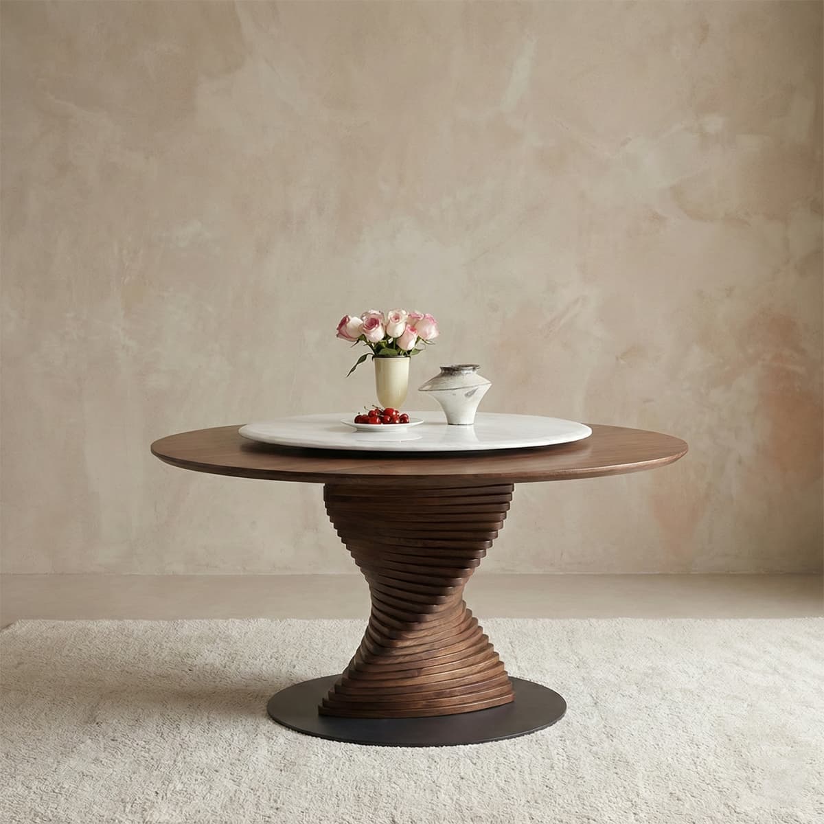 Solid North American Black Walnut round table with sculptural twisted base, decorated with vase of pink roses, cherries on white plate