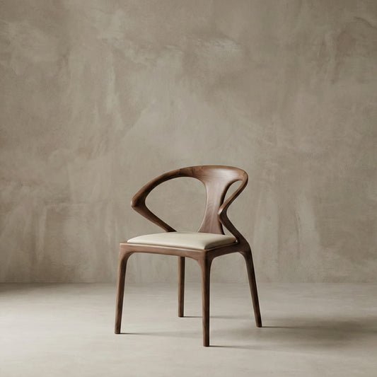 Modern designer chair made from solid North American Black Walnut with cream cushioned seat