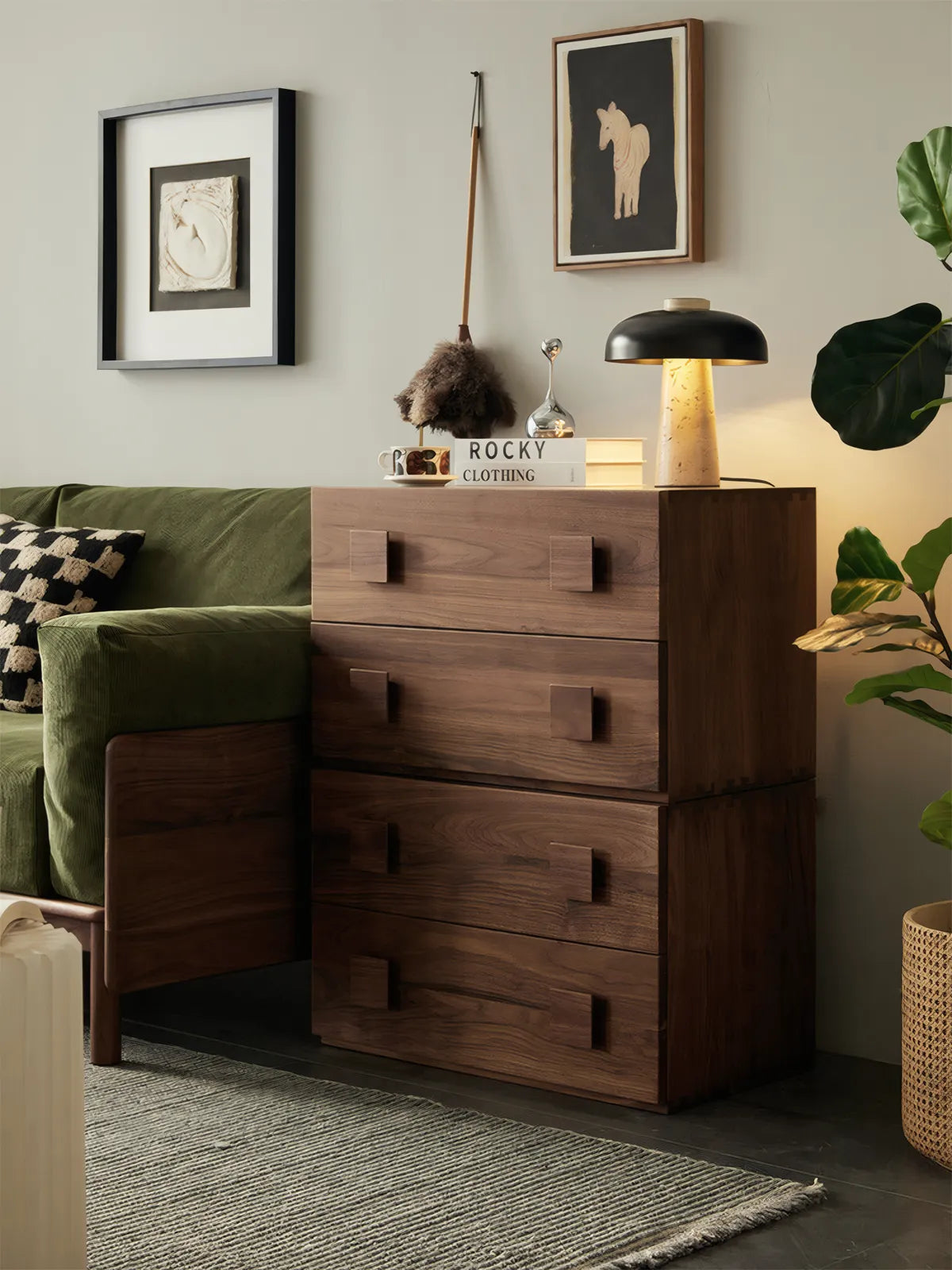 A three-stack configuration of the Walnutry Chronos system serving as a high side table next to a green velvet sofa.