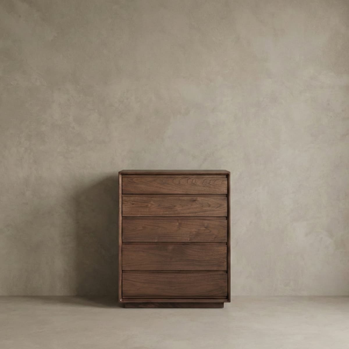 Minimalist solid black walnut five-drawer chest against textured beige wall