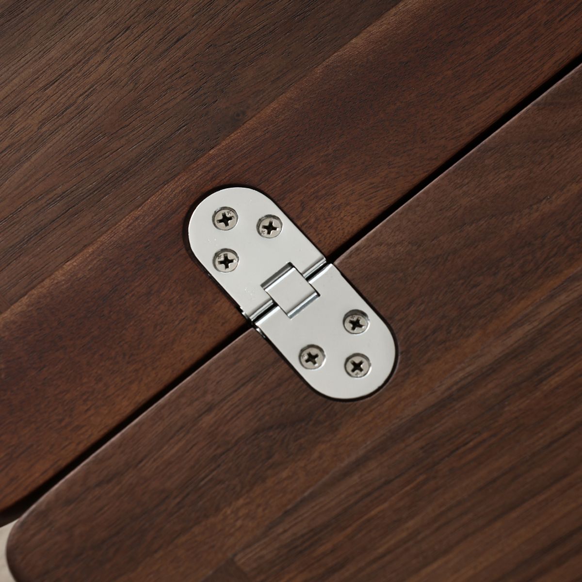 Close-up of silver 360-degree locking hinge on dark wood furniture detail