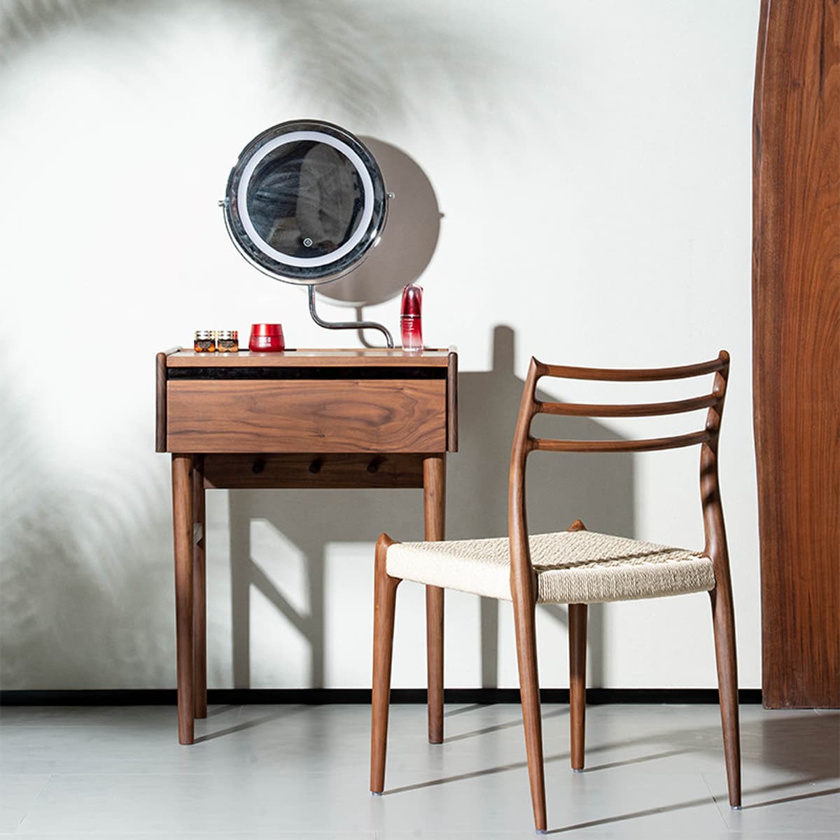Solid North American Black Walnut dressing table with round mirror and woven seat chair in modern room
