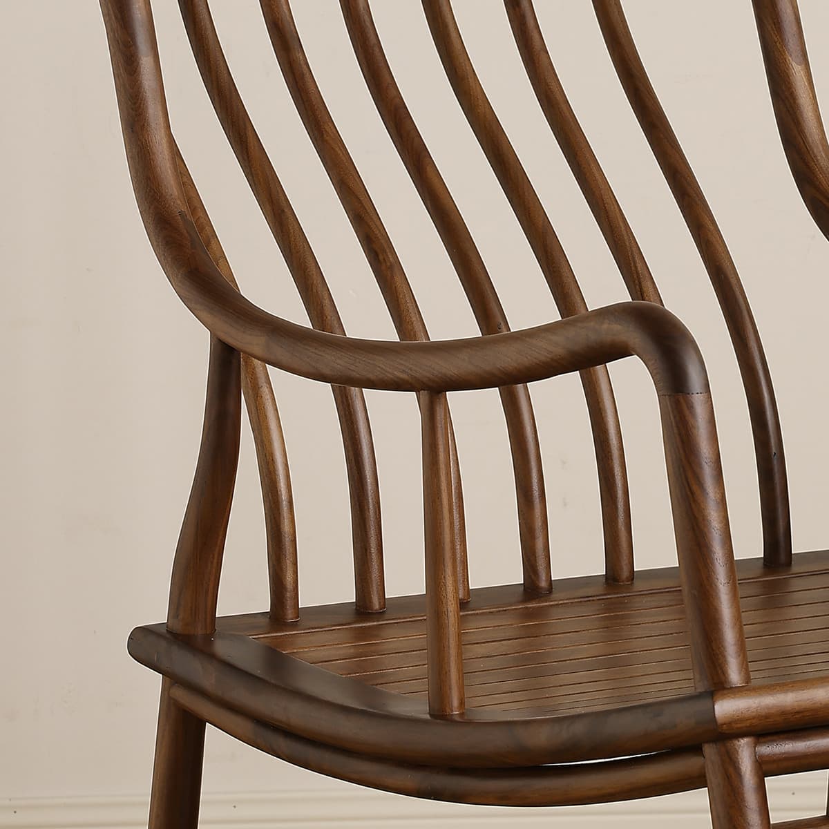 Close-up of finely crafted walnut wood chair with curved slats and smooth finish