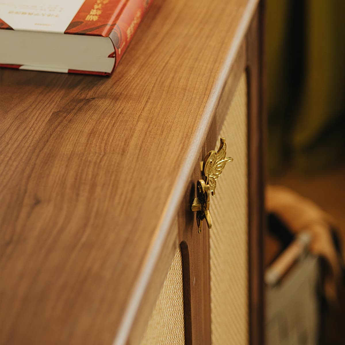 Close-up of solid North American Black Walnut furniture surface with golden butterfly latch and book edge