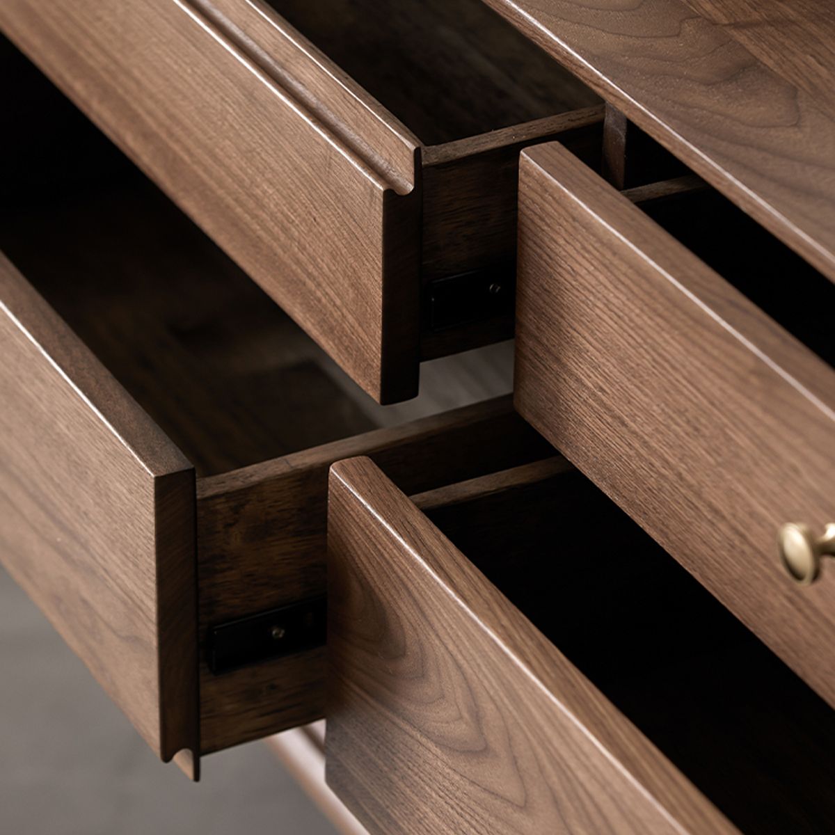 Close-up of open wooden drawers showcasing smooth textured wood grain and craftsmanship