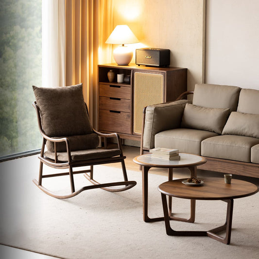 Cozy living room with solid black walnut rocking chair, beige leather sofa, walnut tables, and a wooden cabinet with lamp