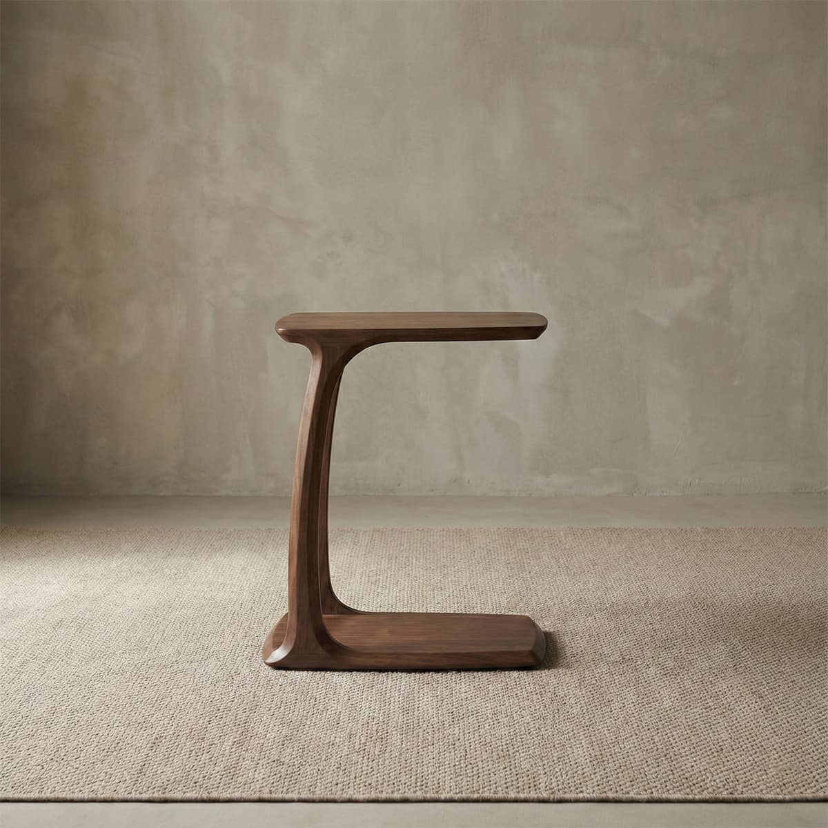 Front view of the standalone Walnutry Helios C-table against a neutral textured background, highlighting its unique, flowing, sculptural design and handcrafted quality.