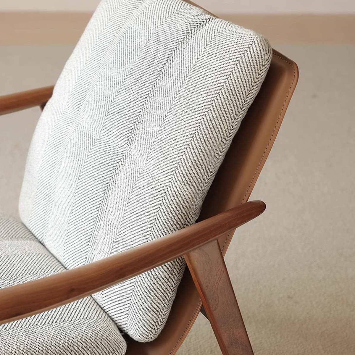 Close-up of a Walnutry mid-century modern chair with solid walnut frame and textured herringbone fabric cushions