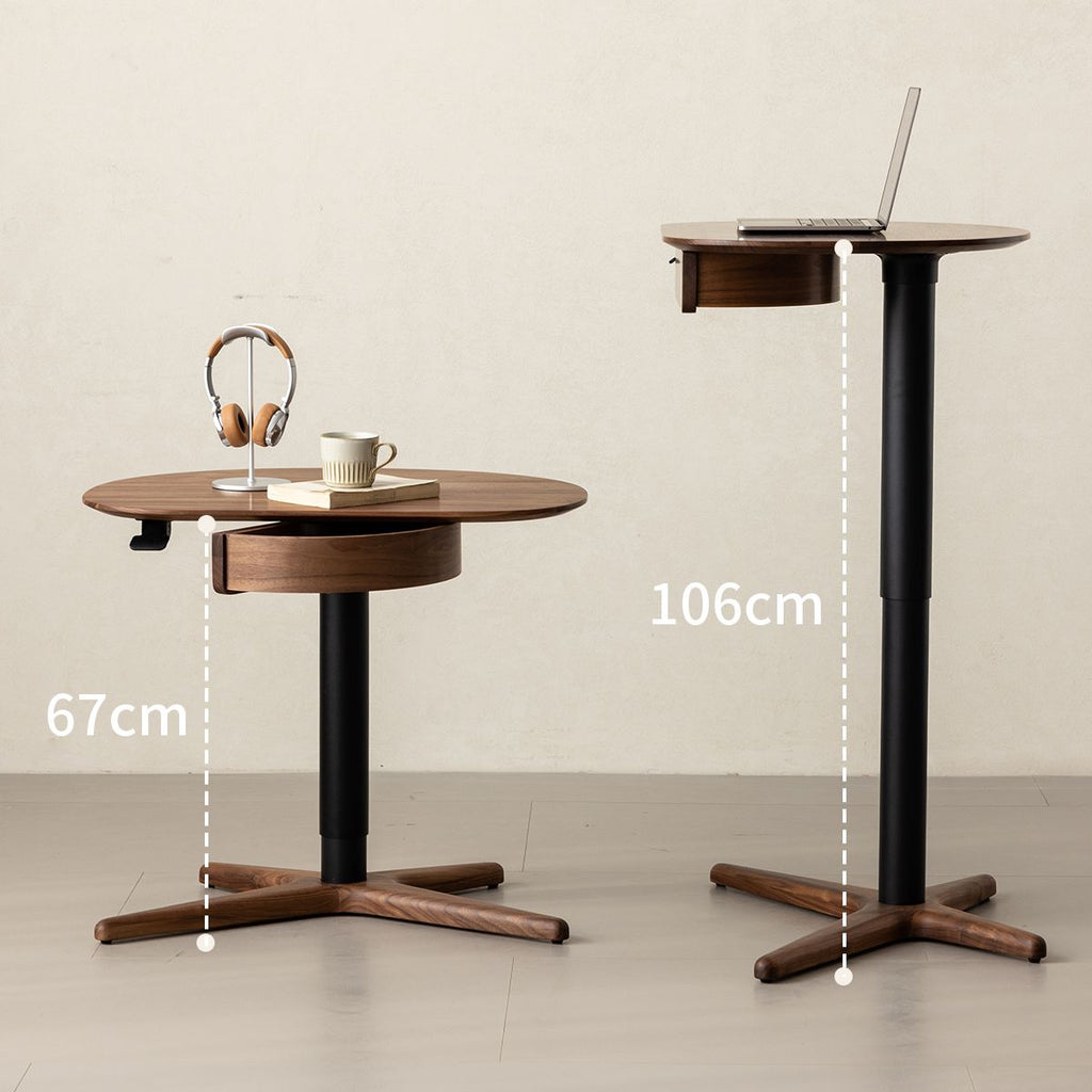Adjustable height walnut side table with black base, shown at 67cm and 106cm heights with laptop and headphones