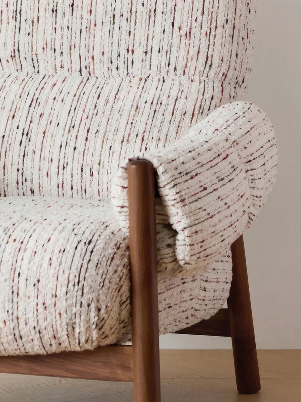 Walnutry Marais Armchair armrest and upholstery detail showing thick cushioning, textured woven fabric, and exposed walnut structure of a mid century upholstered armchair