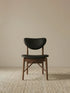 Clean front view of the Sylvan mid century walnut dining chairs, featuring a solid black walnut frame and black leather seat.