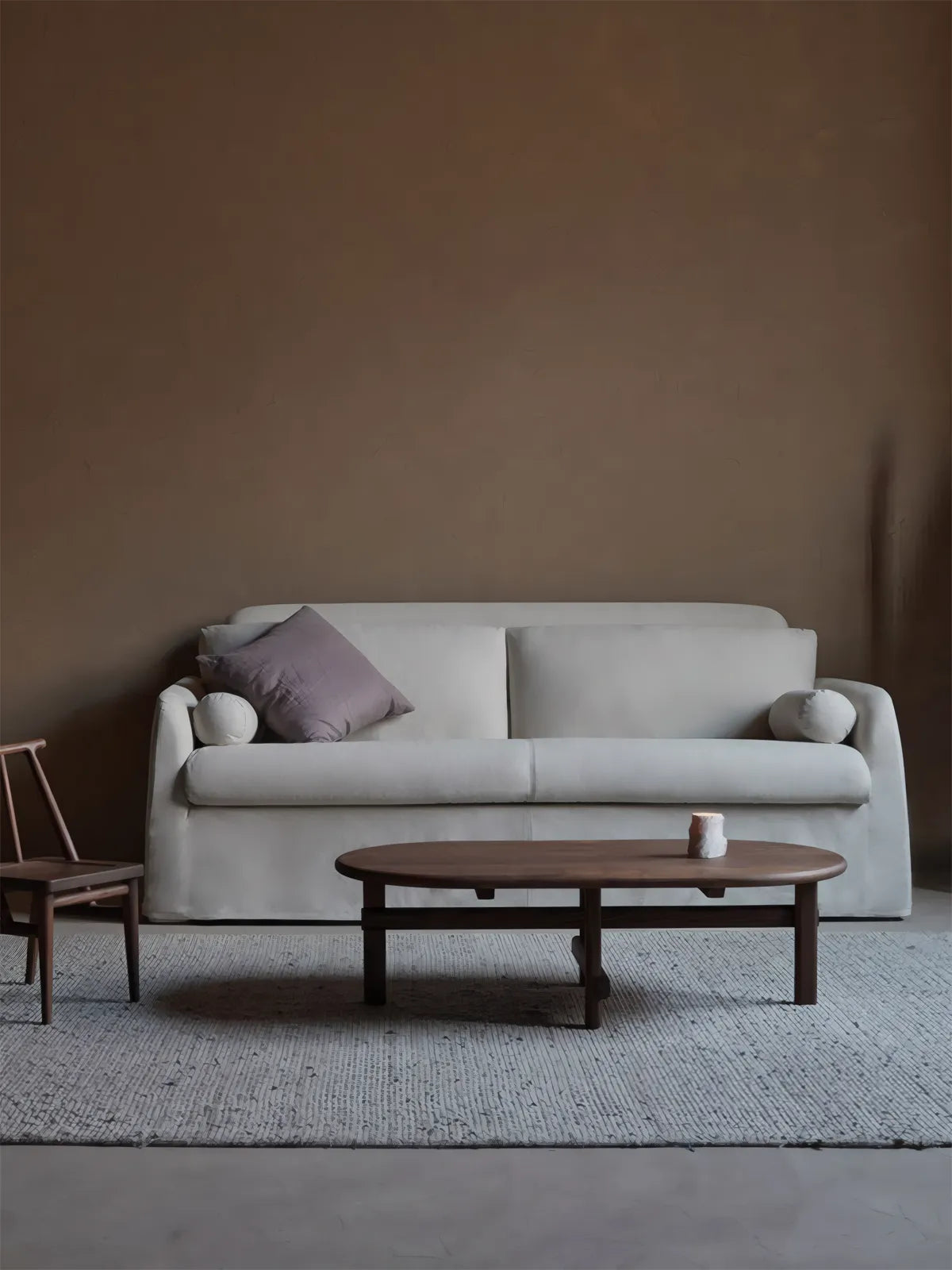 Front view of the Suiseki table in a Wabi-Sabi setting with clay decor, highlighting the smooth matte finish and solid wood cross legs.