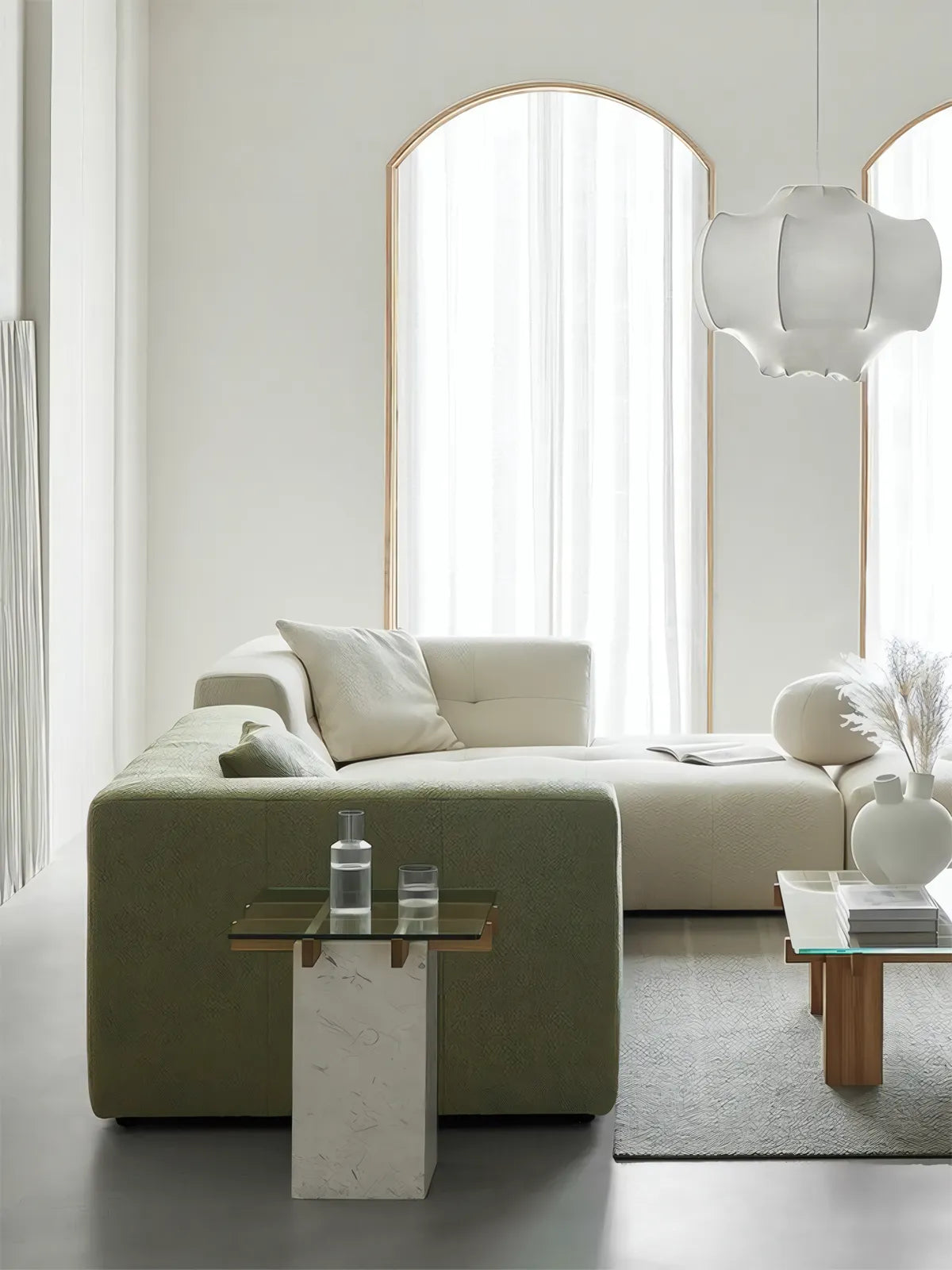 Cumberland walnut side table used as a nightstand in a bright, biophilic bedroom with green sofa.