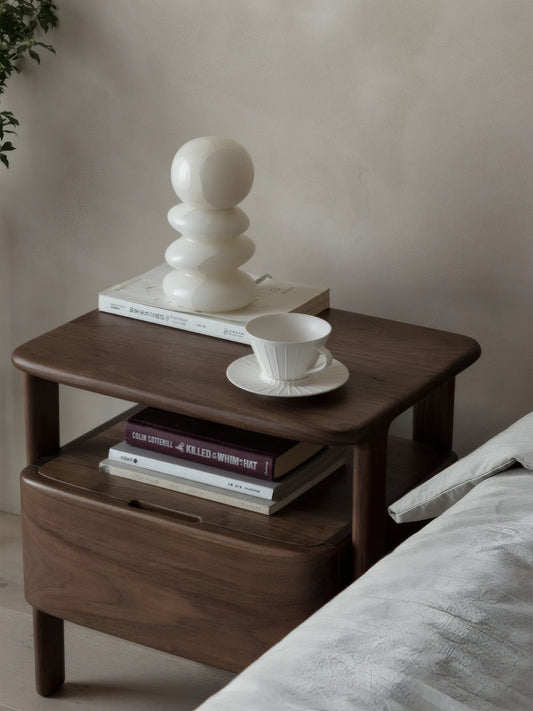 Close-up macro shot of the organic wave grain and matte oil finish on the solid walnut surface.