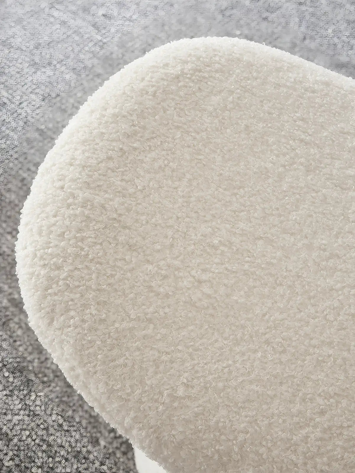 Close-up detail of the premium white bouclé fabric texture on the round seat of the mushroom ottoman, highlighting the soft and knobby weave.