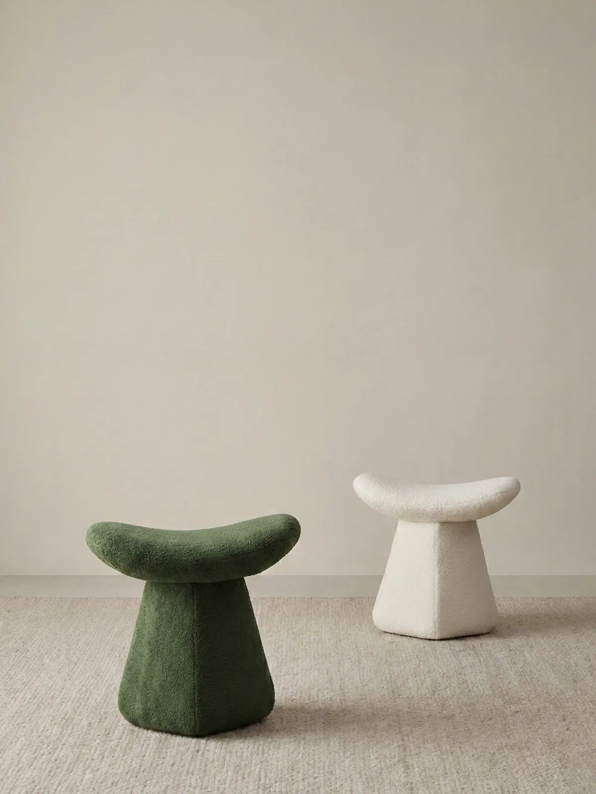 Comparison of the Cumberland mushroom stool in Moss Green and Cream White bouclé, highlighting color options for different interior styles.