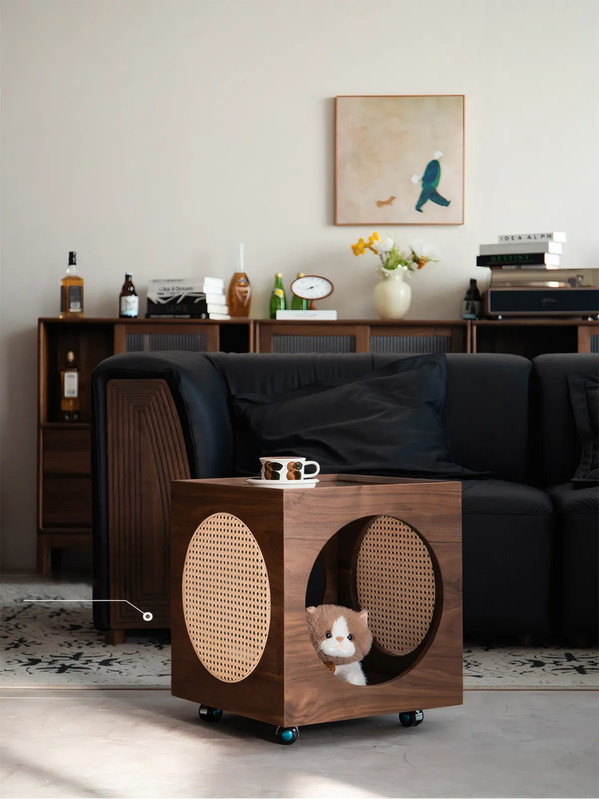 A cat resting inside the Sylvan walnut cat condo, highlighting the spacious interior and hidden caster wheels for mobility