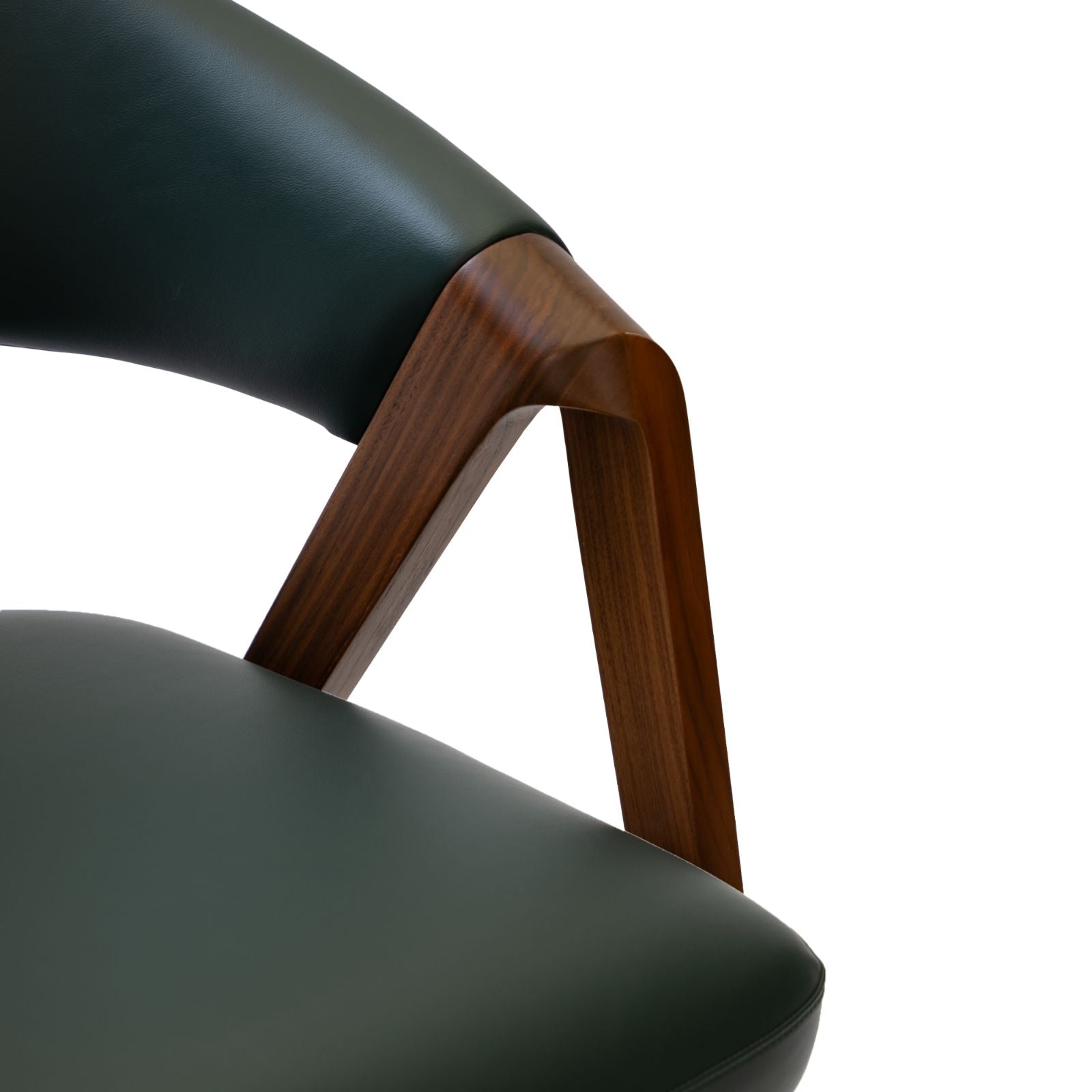 Close-up of dark green leather chair with smooth wooden armrest and modern design
