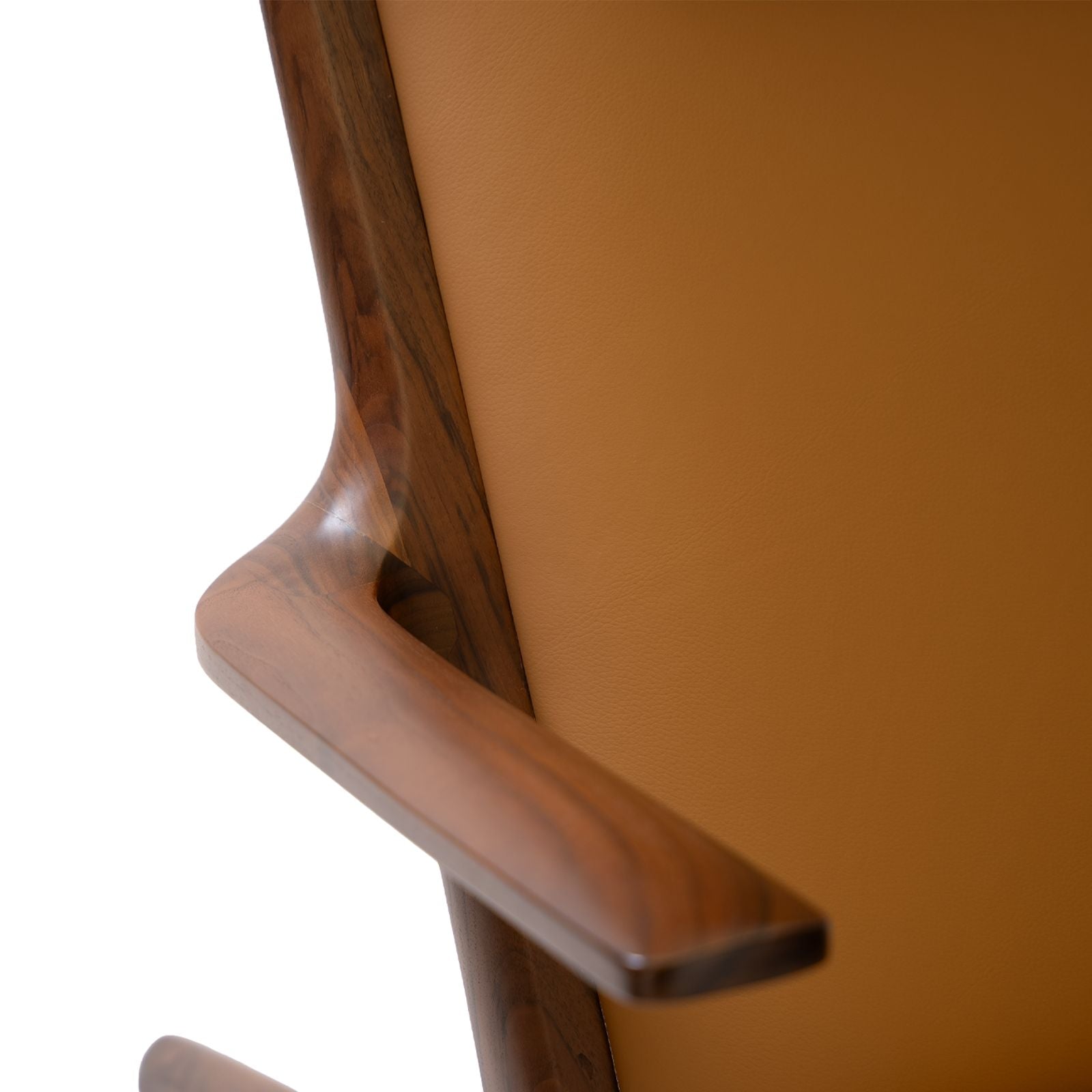 Close-up of a modern chair armrest with smooth walnut wood and tan leather upholstery