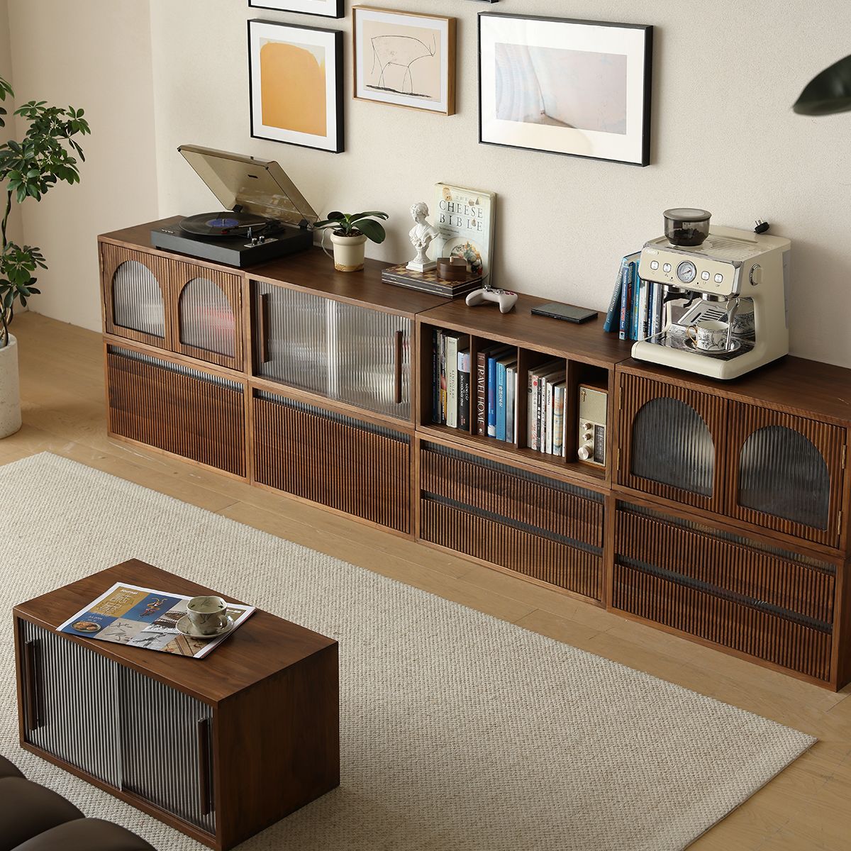 Modern living room with wooden cabinet featuring record player, espresso machine, books, and decor