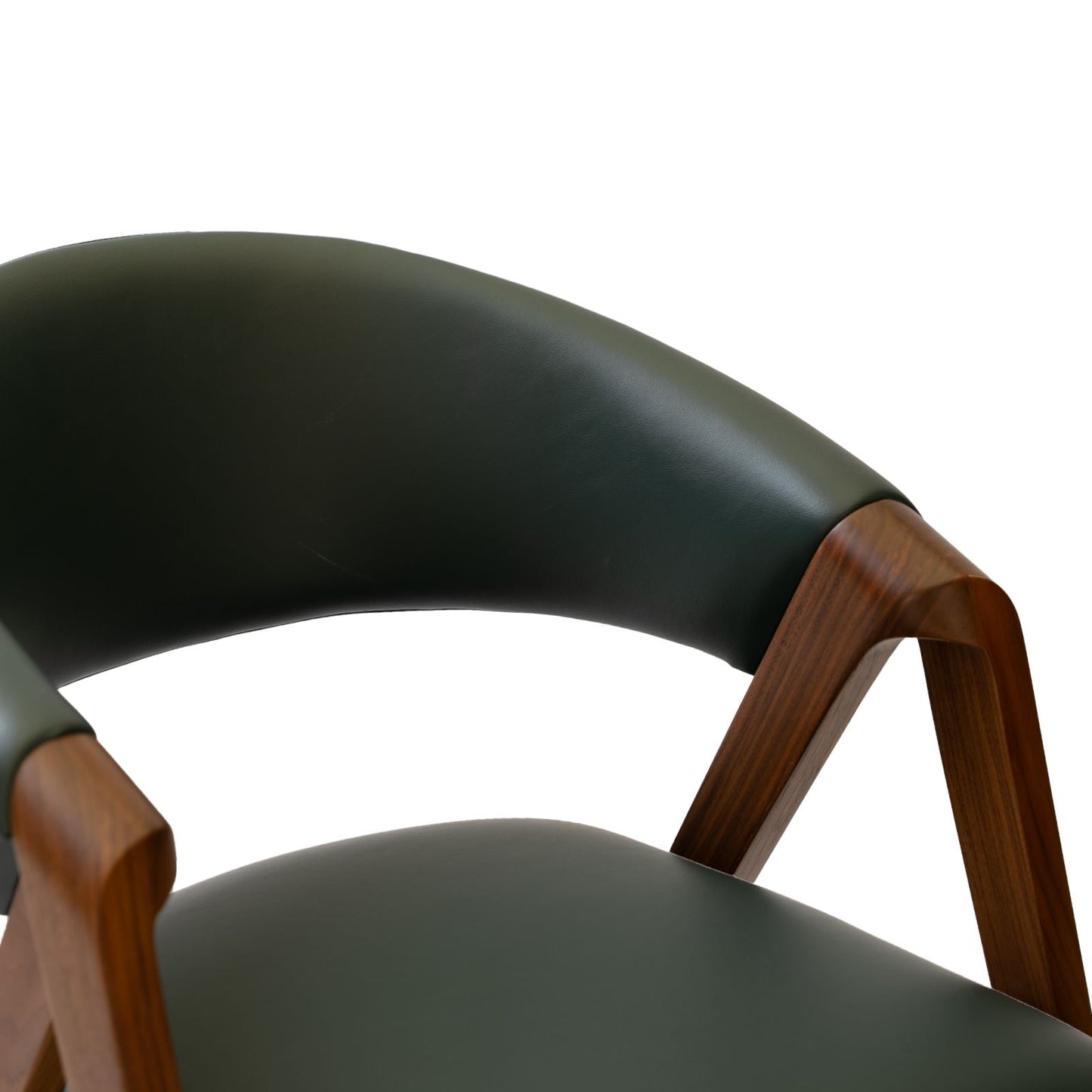 Close-up of modern green leather chair with curved backrest and wooden armrest detail