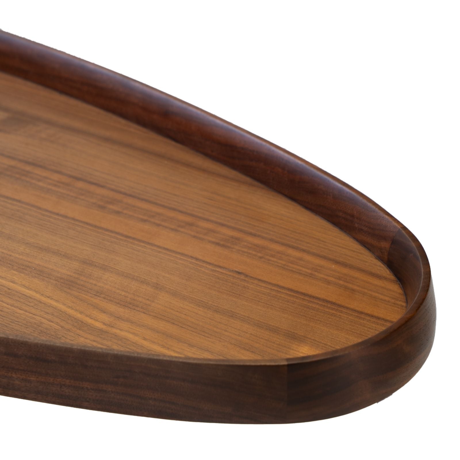 Close-up of a wooden serving tray with rounded edges and smooth finish
