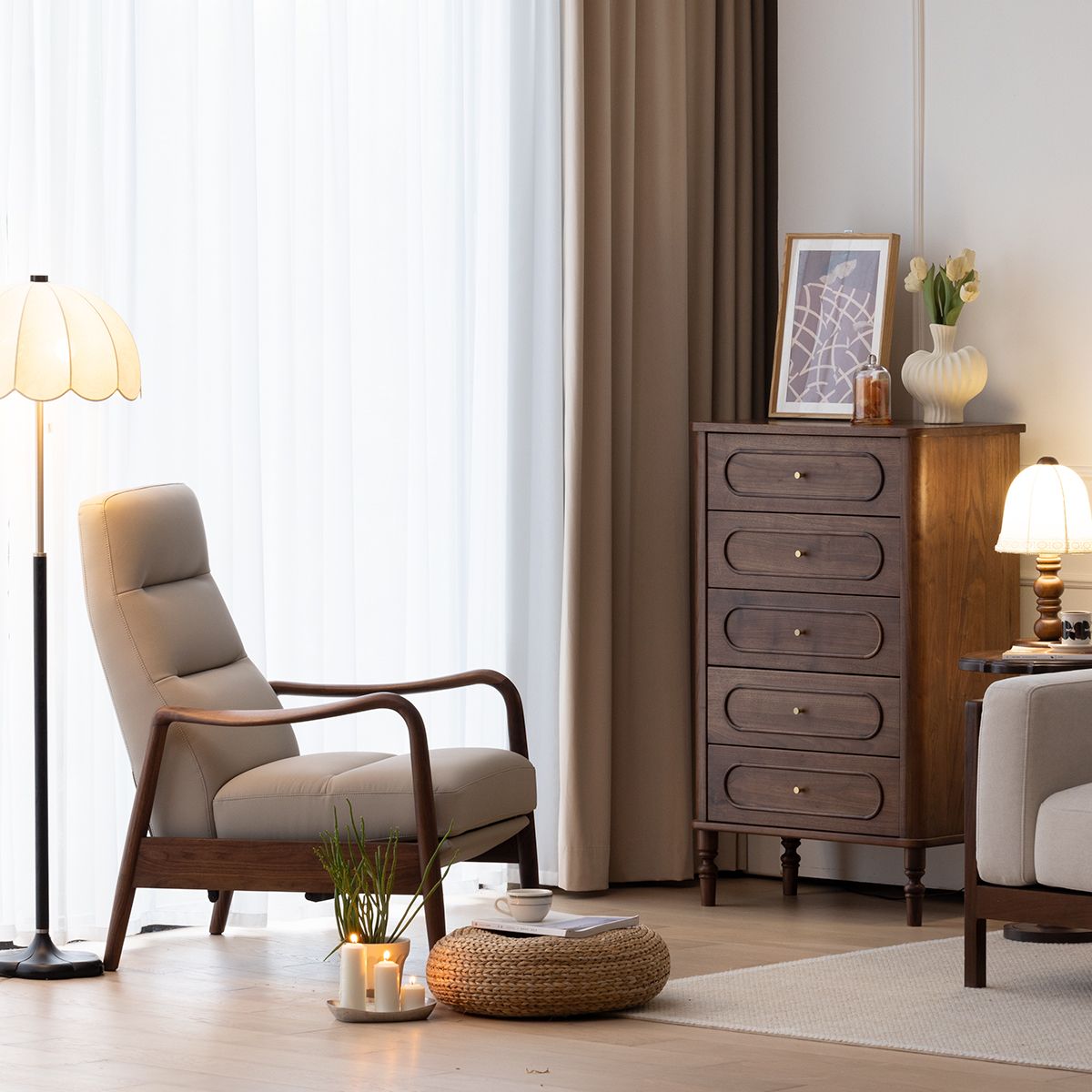 Living room with beige cushioned walnut armchair, tall walnut chest of drawers, warm lighting, and cozy decor