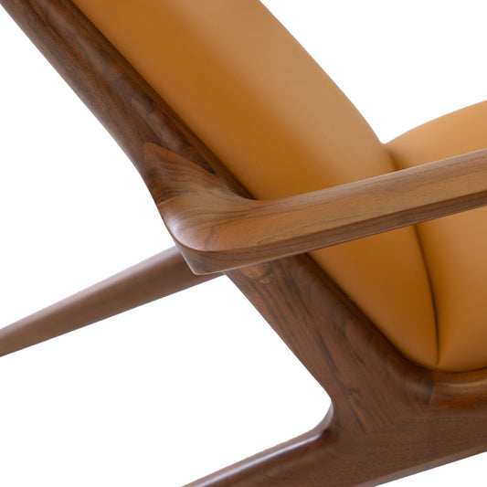 Close-up of wooden armrest and tan leather upholstery on modern mid-century chair