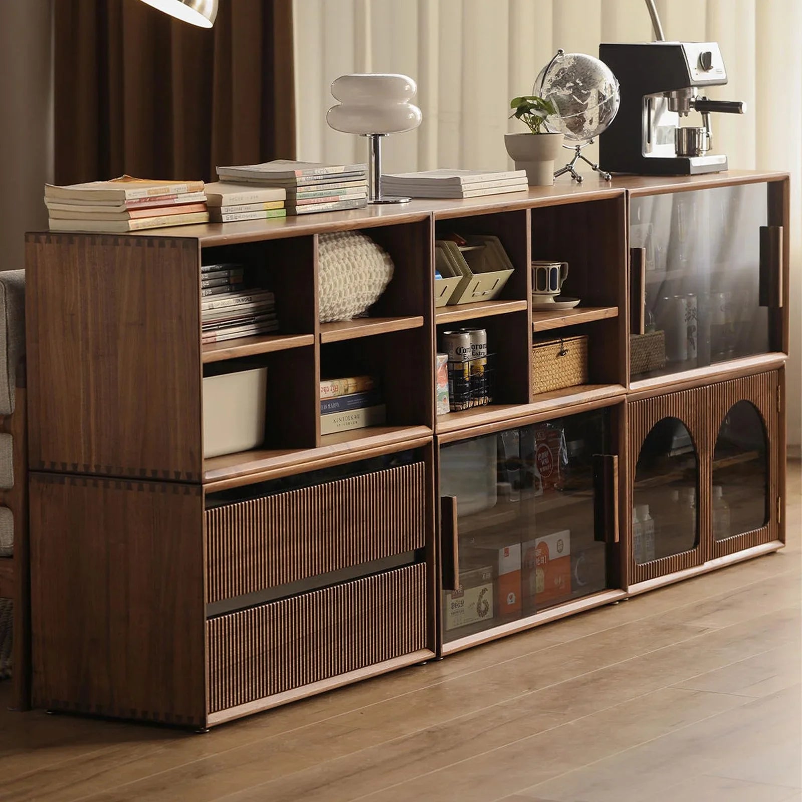 modern wooden shelving unit with books, lamp, globe, coffee machine, and storage compartments
