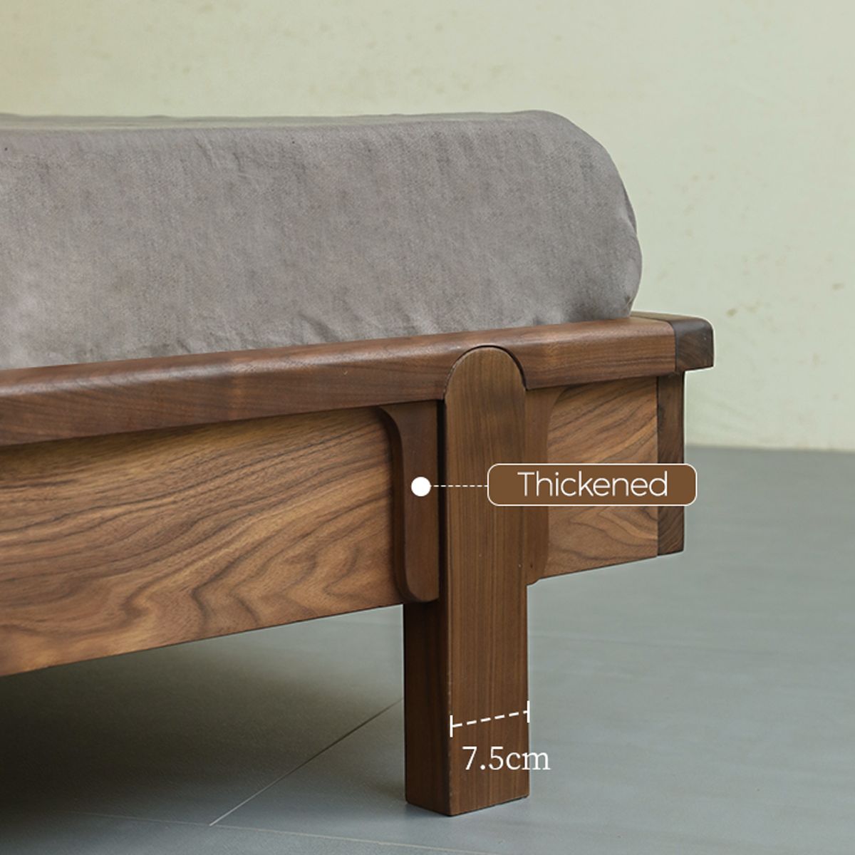 Close-up of thickened 7.5cm wooden bed frame leg with grey upholstered headboard